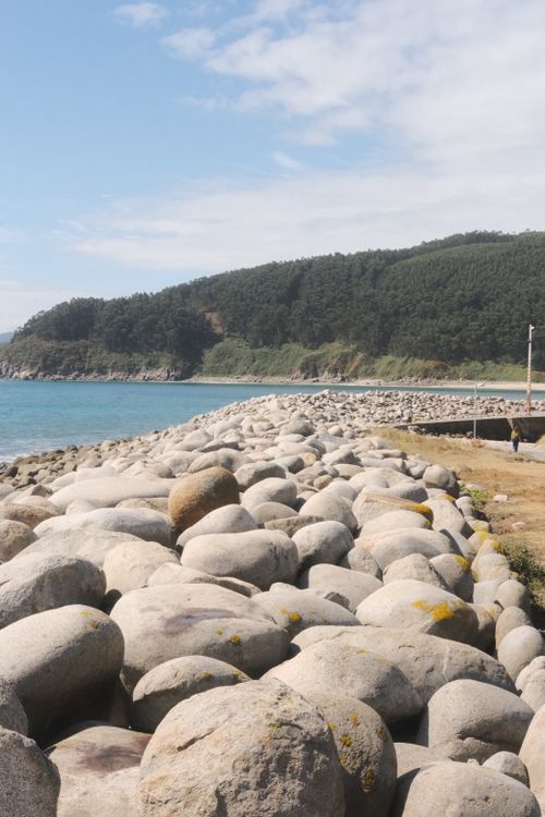 Free Discover the rocky coastline of Galicia, Spain with a serene ocean view and lush hills. Stock Photo