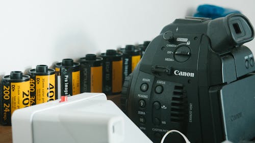 Close-Up Photo Of Camera Beside Films