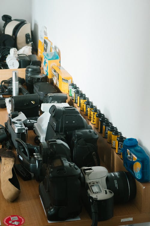 Photo Of Black Cameras On Wooden Table