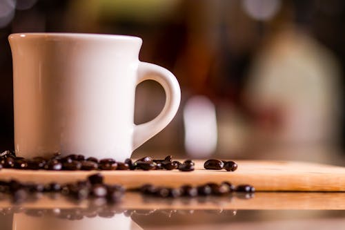 White Ceramic Mug on Brown Wooden Table