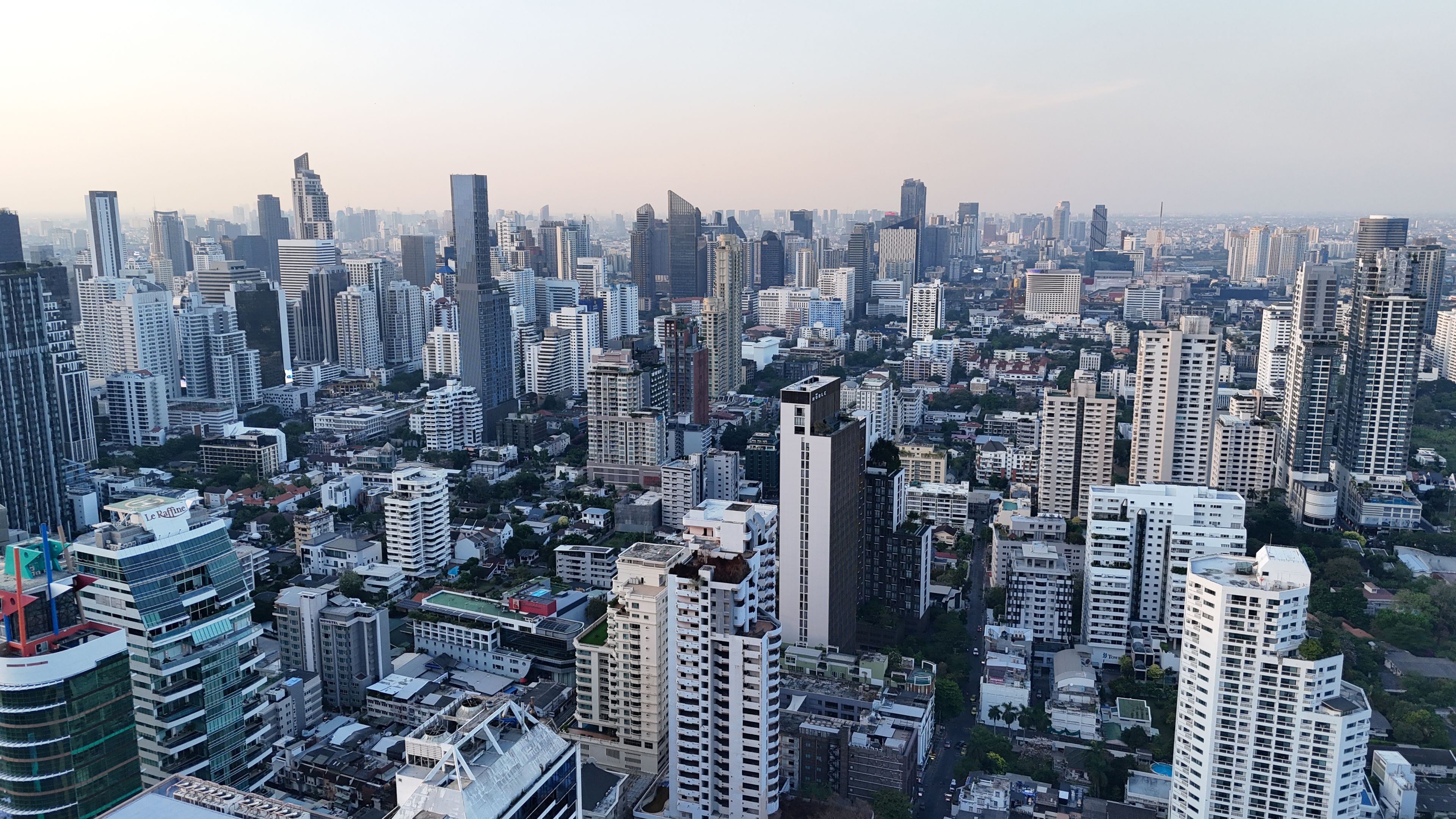 A breathtaking aerial view of the bustling Bangkok skyline at dusk highlighting modern skyscrapers.