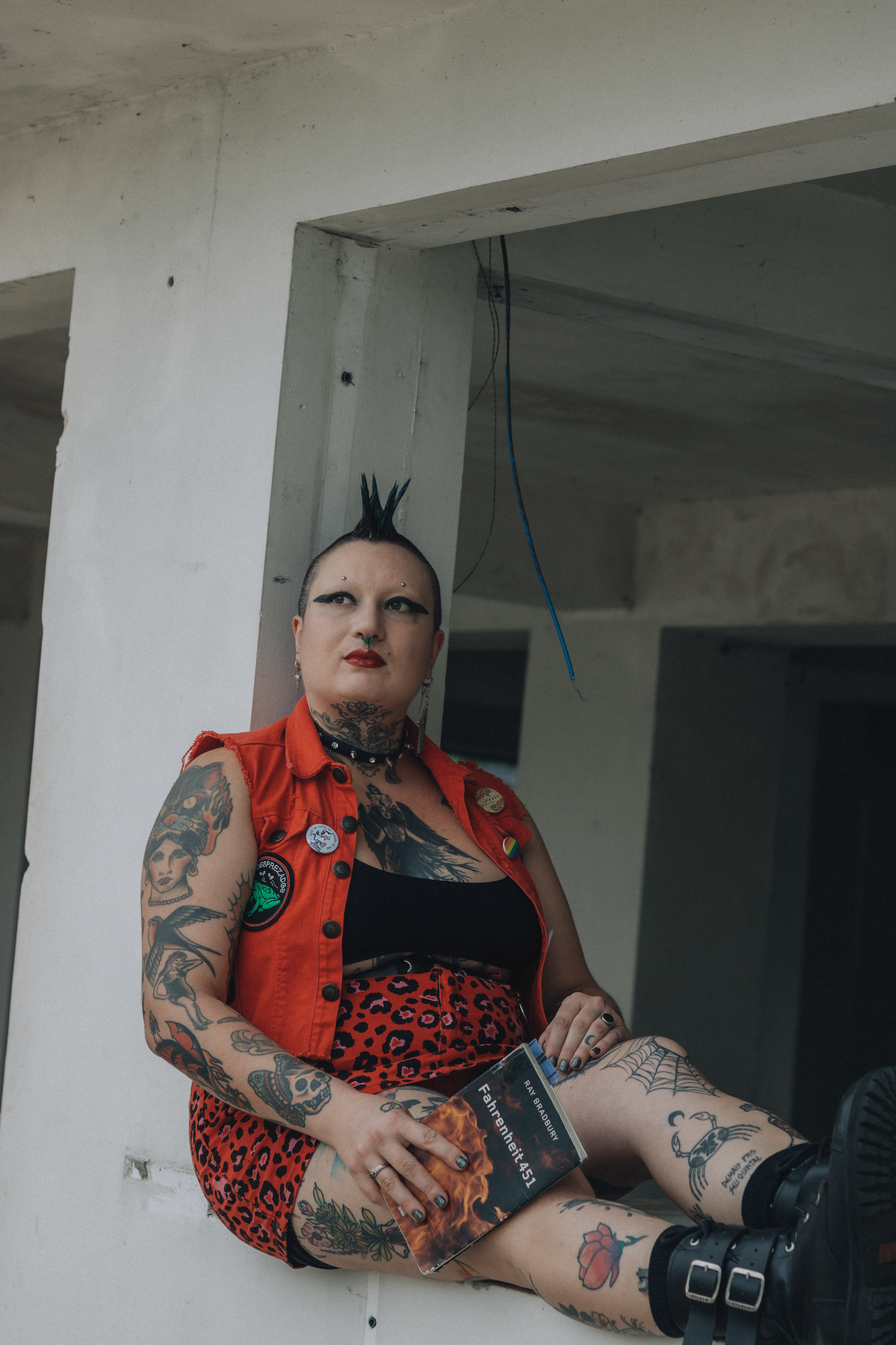 Punk Style Woman Sitting Indoors with Tattoo Art · Free Stock Photo