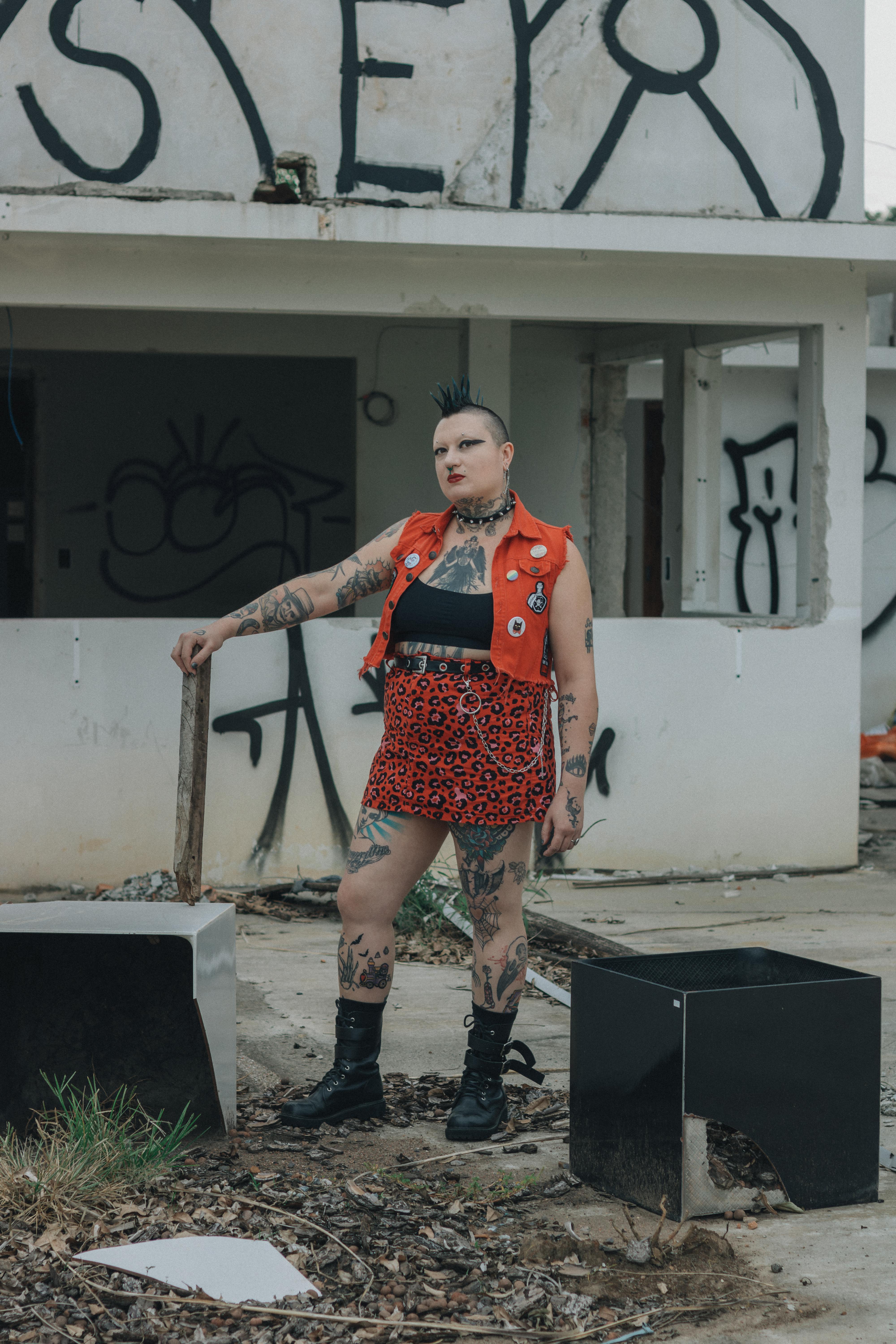 免費 身著龐克裝束的人站在城市塗鴉背景前。 圖庫相片