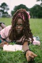 Young Woman Relaxing Outdoors with a Book