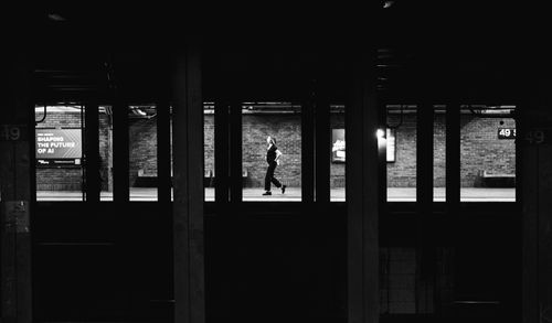 Free Dramatic black and white photo of a lone commuter in a New York subway station. Stock Photo