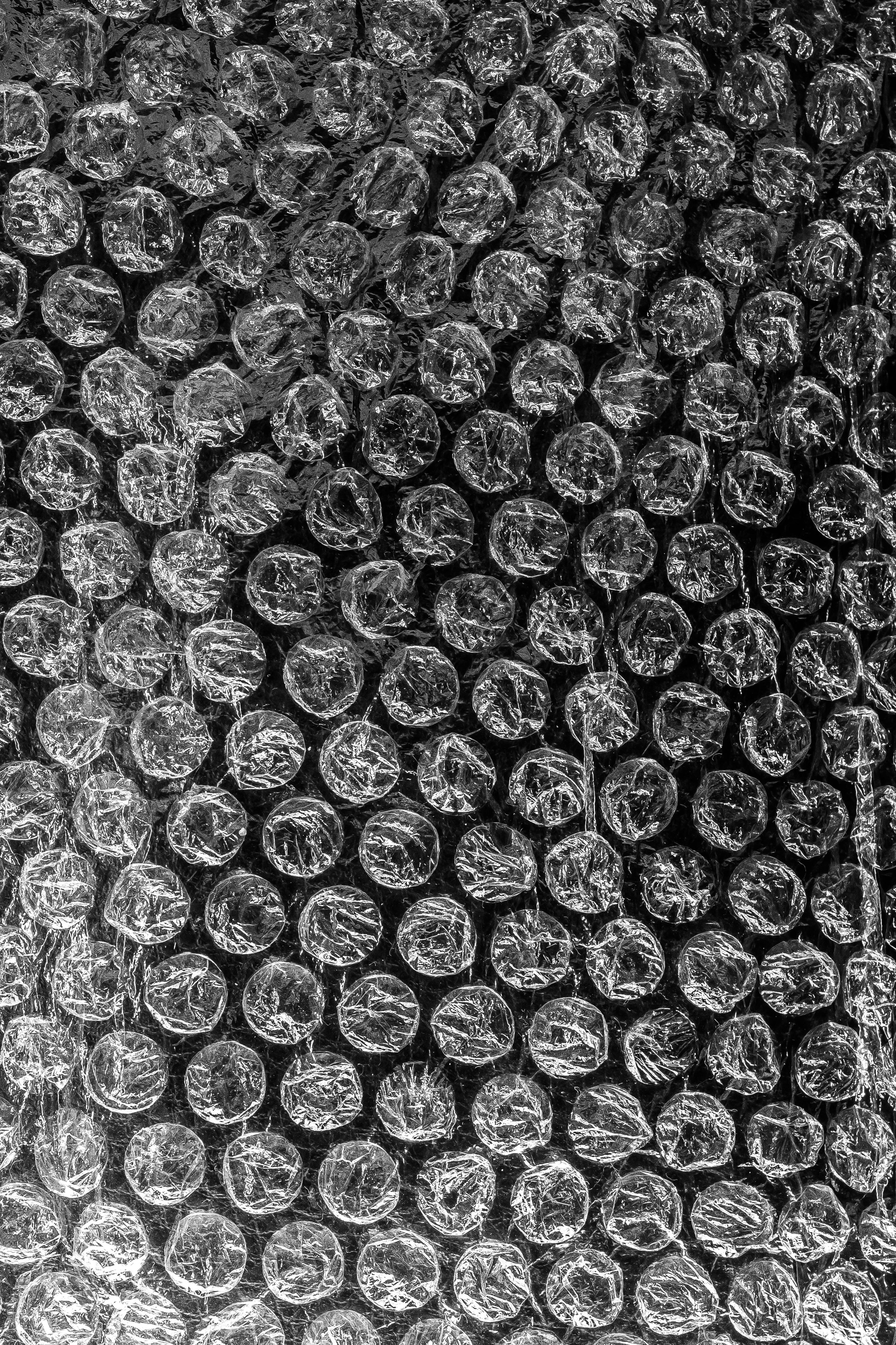 Free Detailed black and white close-up of bubble wrap showcasing its unique texture. Stock Photo