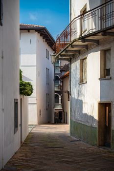 Discover a picturesque alley in San Daniele del Friuli with traditional Italian architecture.