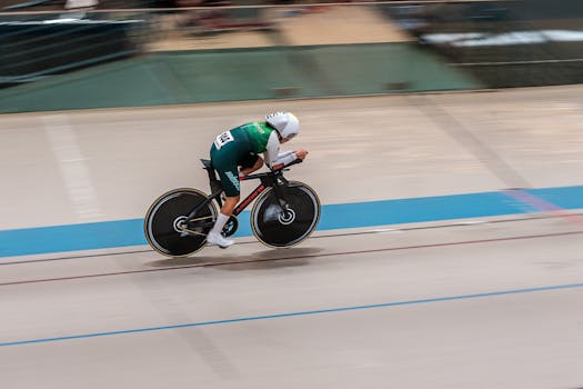 Dynamic image of a cyclist racing on a velodrome track showcasing speed and endurance.