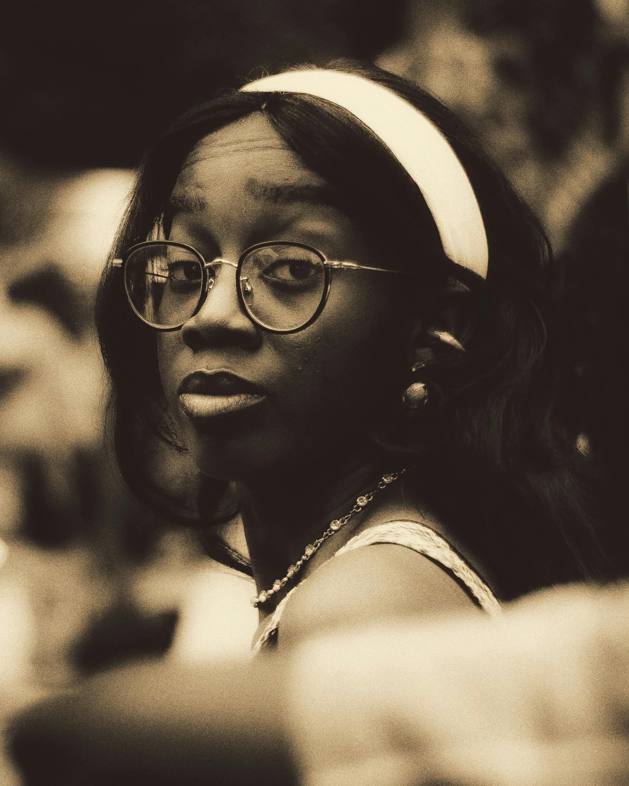 Gratis En stilig kvinne med briller og pannebånd i et vintage sepiaportrett. Arkivbilde