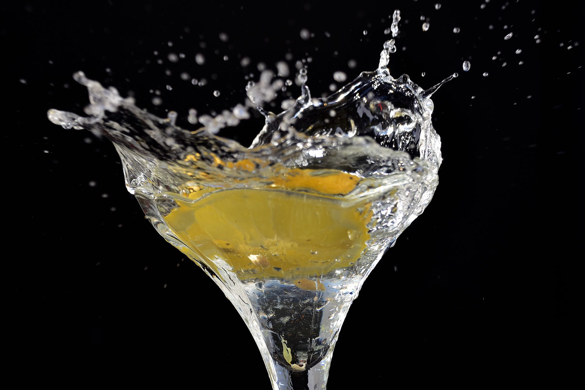 Classic martini glass with olive garnish on a wooden table