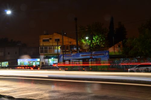 Free Colorful light trails on a city street at night, capturing urban nightlife and movement. Stock Photo
