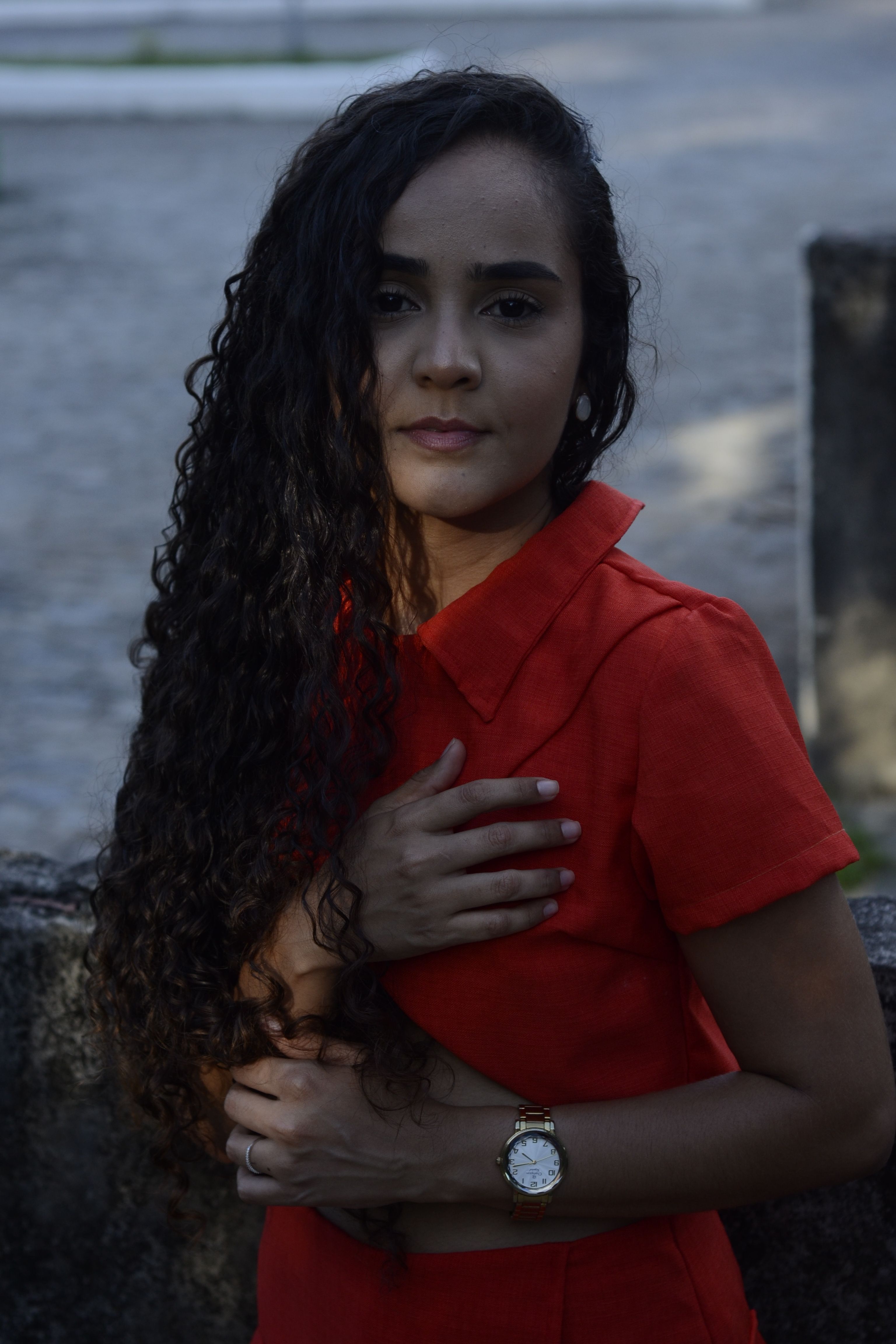 Woman in Red Dress with Curly Hair Outdoors · Free Stock Photo
