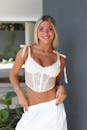 Smiling Woman in Stylish White Lace Top