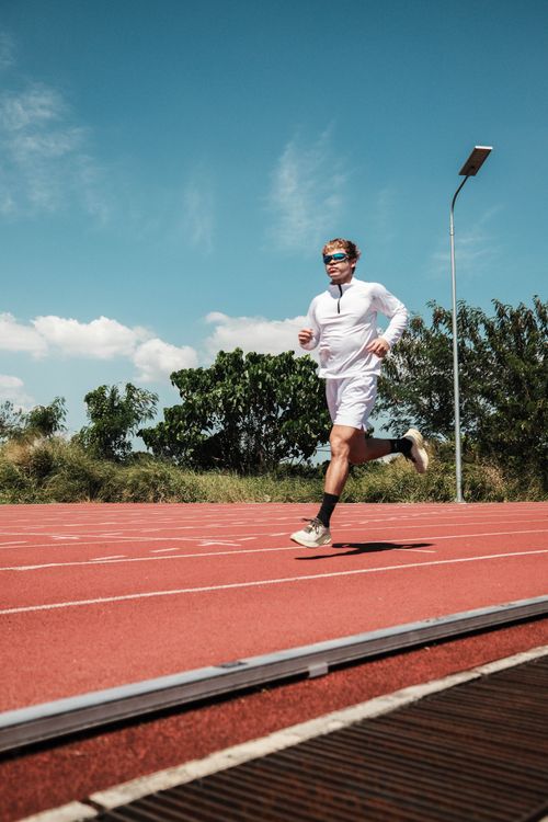 Free A focused athlete jogging on a sunny day on an outdoor track in Taytay, Philippines. Stock Photo