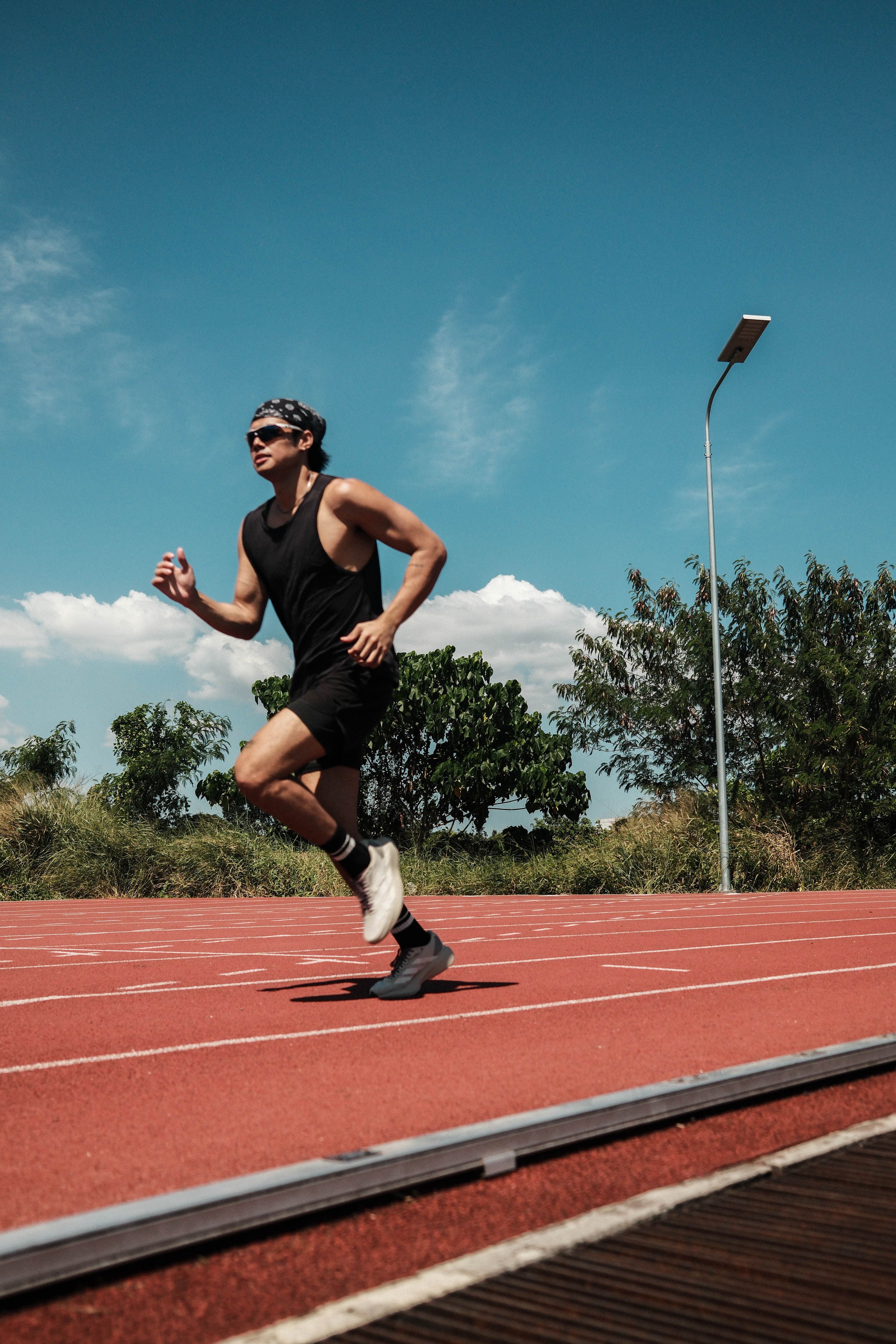 Filipino Athlete Running on Track in Taytay · Free Stock Photo