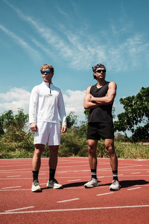 Free Two athletes standing on an outdoor track in Taytay, Philippines, ready for training. Stock Photo