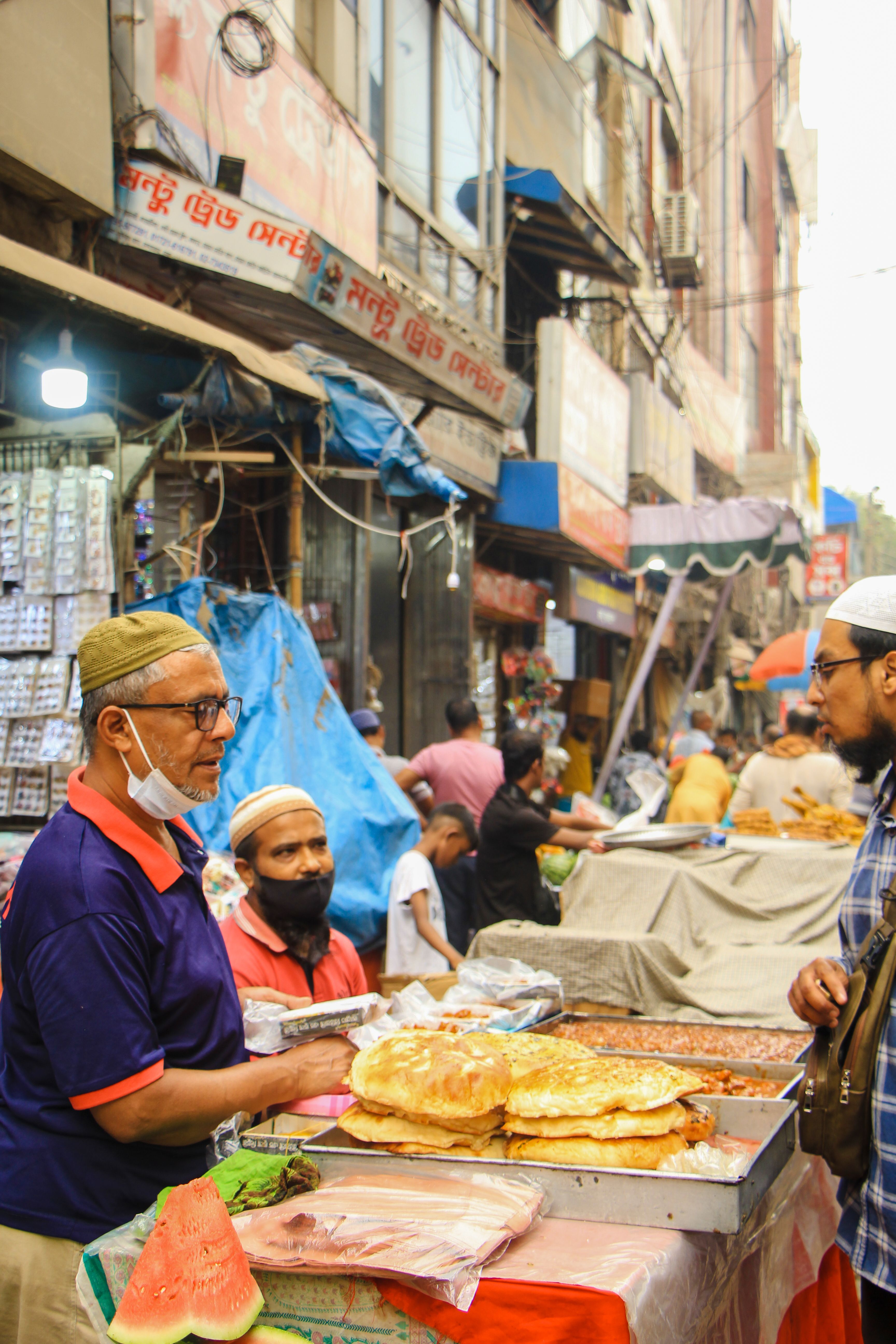 Lively street scene in Dhaka bazaar, Bangladesh with vendors and customers, highlighting local culture.