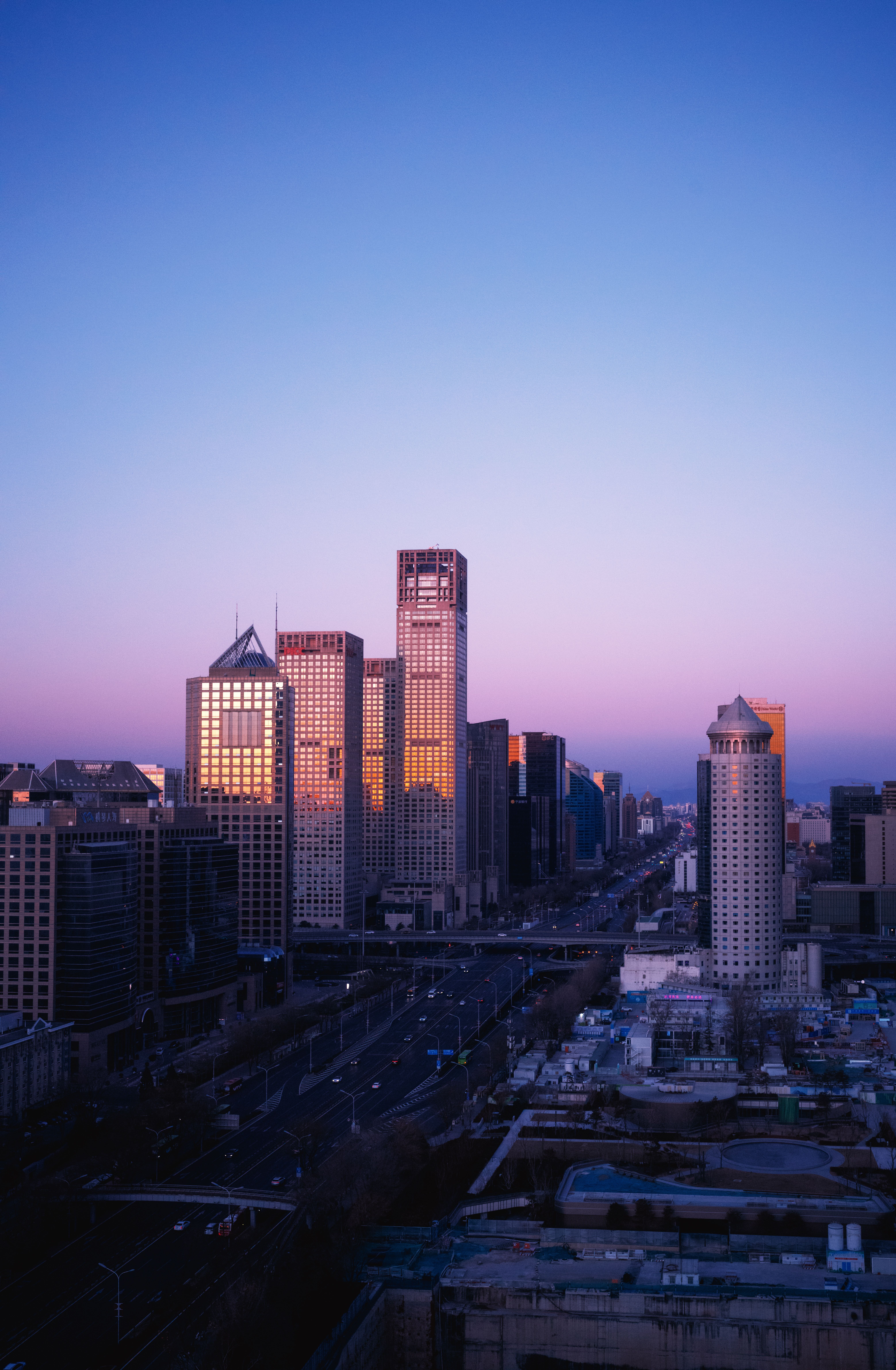 A stunning view of Beijing's modern skyscrapers at dusk, reflecting the twilight sky.