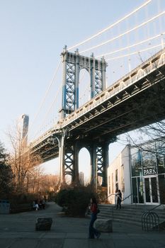 Iconic view of the Manhattan Bridge from Brooklyn, capturing the urban landscape under clear daylight.