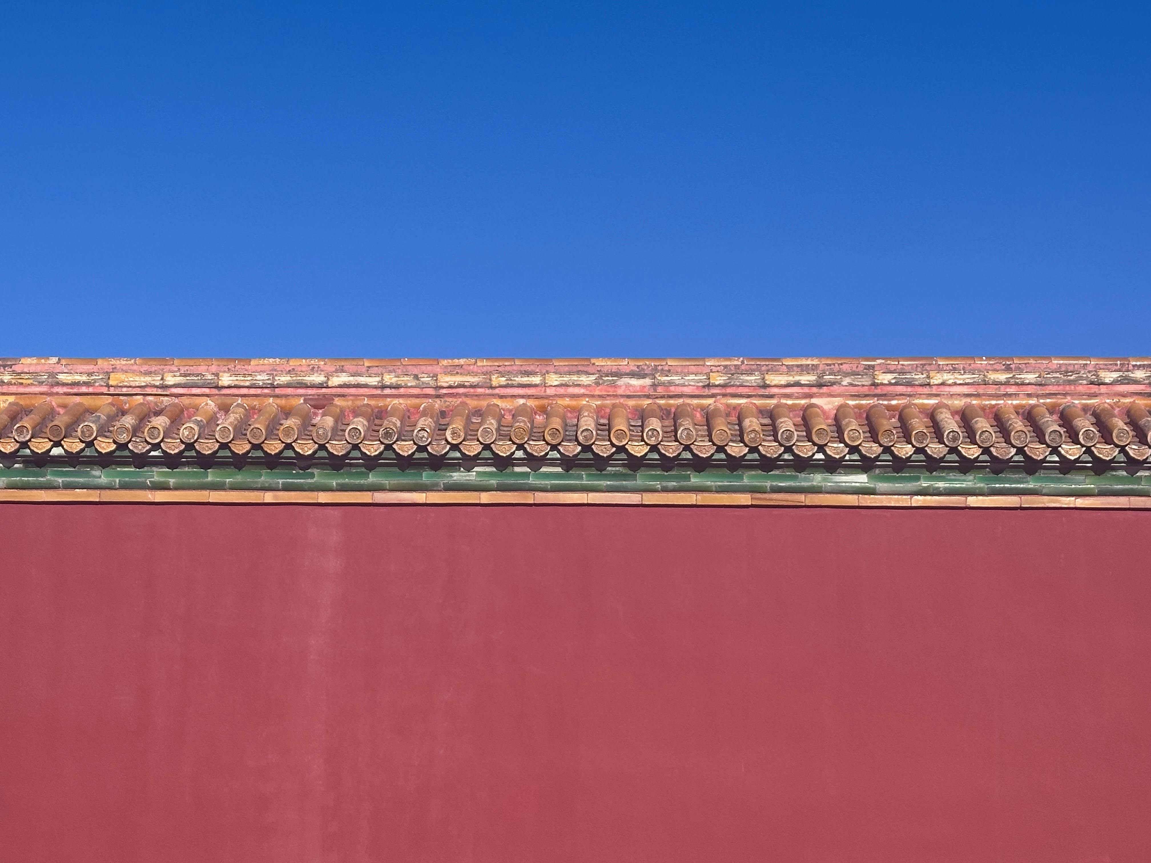 Free A classic Chinese architectural roof with vibrant blue sky, showcasing traditional tiles and design. Stock Photo