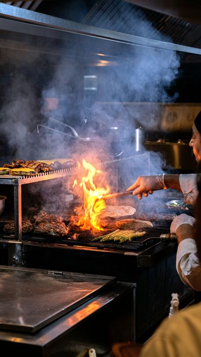 Chef grilling with flames