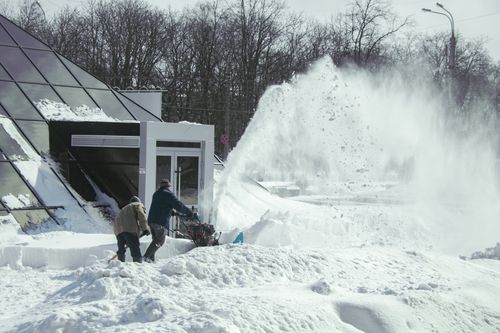 Free Workers clearing heavy snow with machinery in Chernihiv during winter. Stock Photo