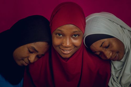 Free Three women in colorful hijabs pose together, exuding warmth and friendship. Stock Photo