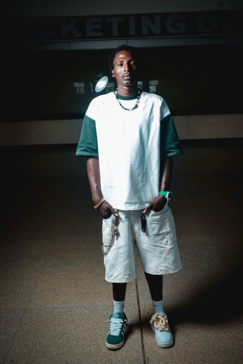 Free A stylish man in urban streetwear poses confidently indoors. Stock Photo