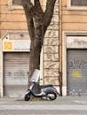 Vintage Vespa Parked by Historic Roman Building