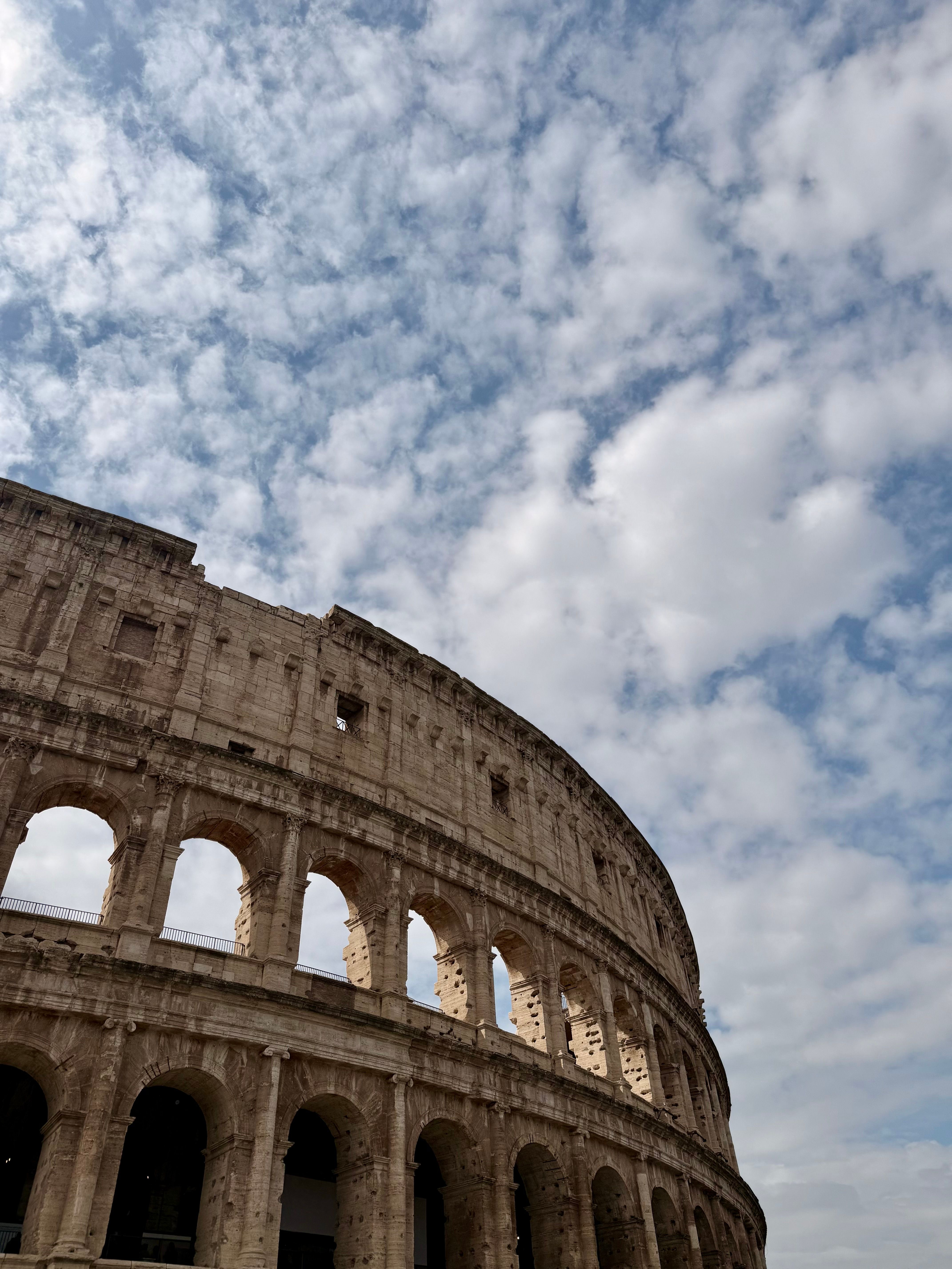 Iconic Colosseum Under Dramatic Sky · Free Stock Photo