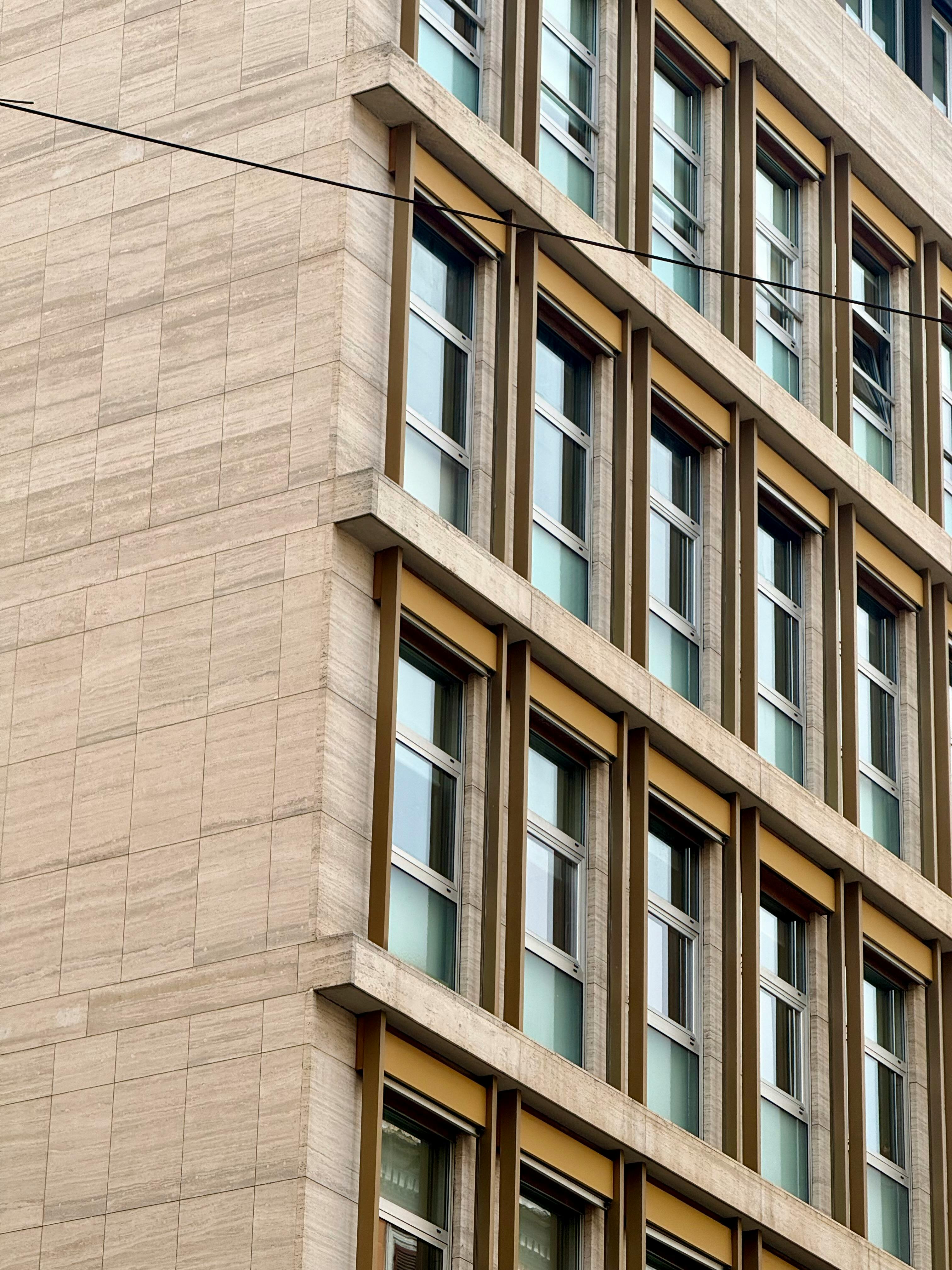 Free A detailed view of a modern architectural building facade in Rome with large windows. Stock Photo