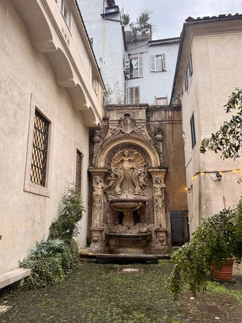 Free Explore a hidden baroque fountain in a charming historic alleyway of Rome, Italy. Stock Photo