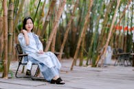 Woman Relaxing in Bamboo Forest Setting