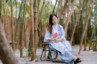 Young Woman Reading in Bamboo Garden