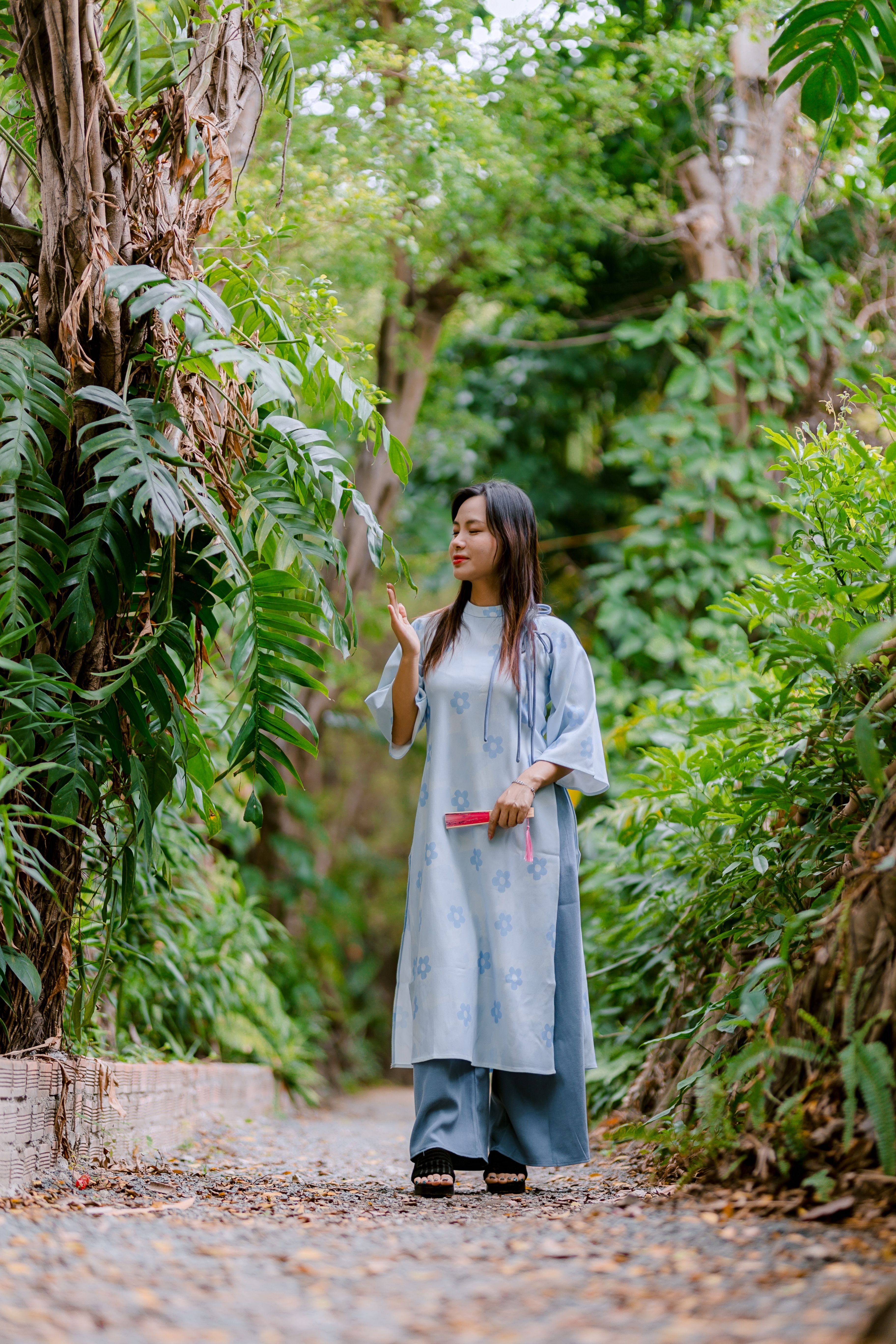 Woman in Blue Dress Walking in a Green Forest Pathway · Free Stock Photo