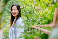 Portrait of a Smiling Woman in Lush Garden