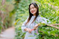 Young Woman Smiling in Lush Green Garden