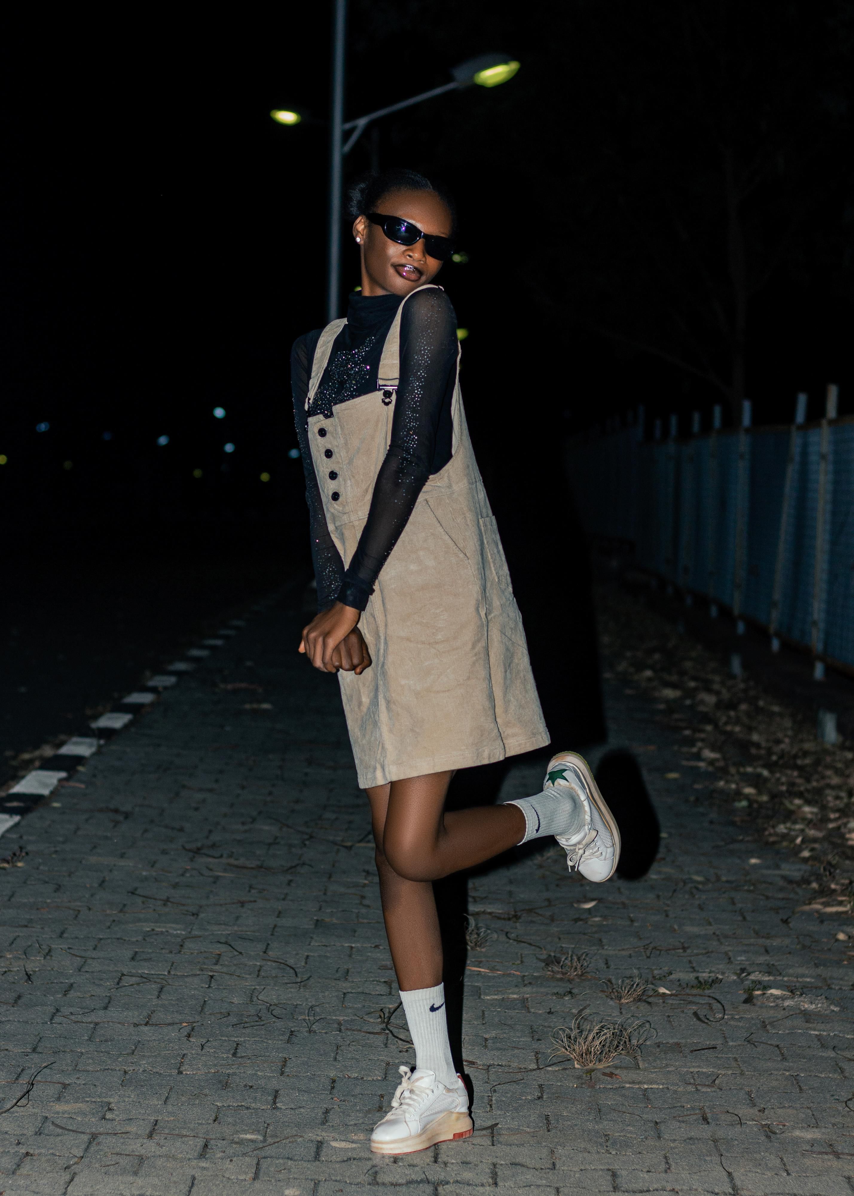Stylish Young Woman Posing Outdoors at Night · Free Stock Photo