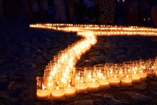 Warm candlelit path arrangement on cobblestones during a night event in Pedraza, Spain.