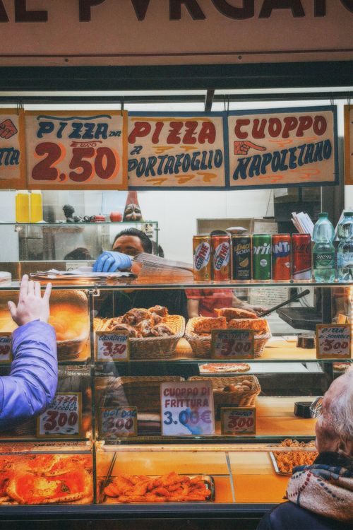 Free Authentic Italian street food stall in Naples offering pizza and traditional cuoppo fritters. Stock Photo