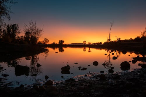 Body Of Water During Sunset