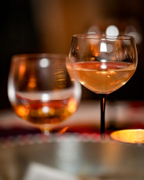 Free Close-up of elegant wine glasses with a warm, ambient glow, perfect for evening gatherings. Stock Photo