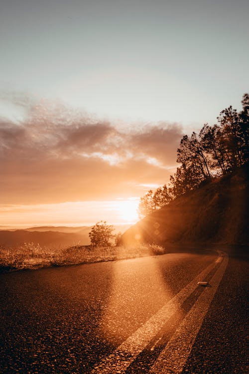 Photo Of  An Empty Road During Dawn 