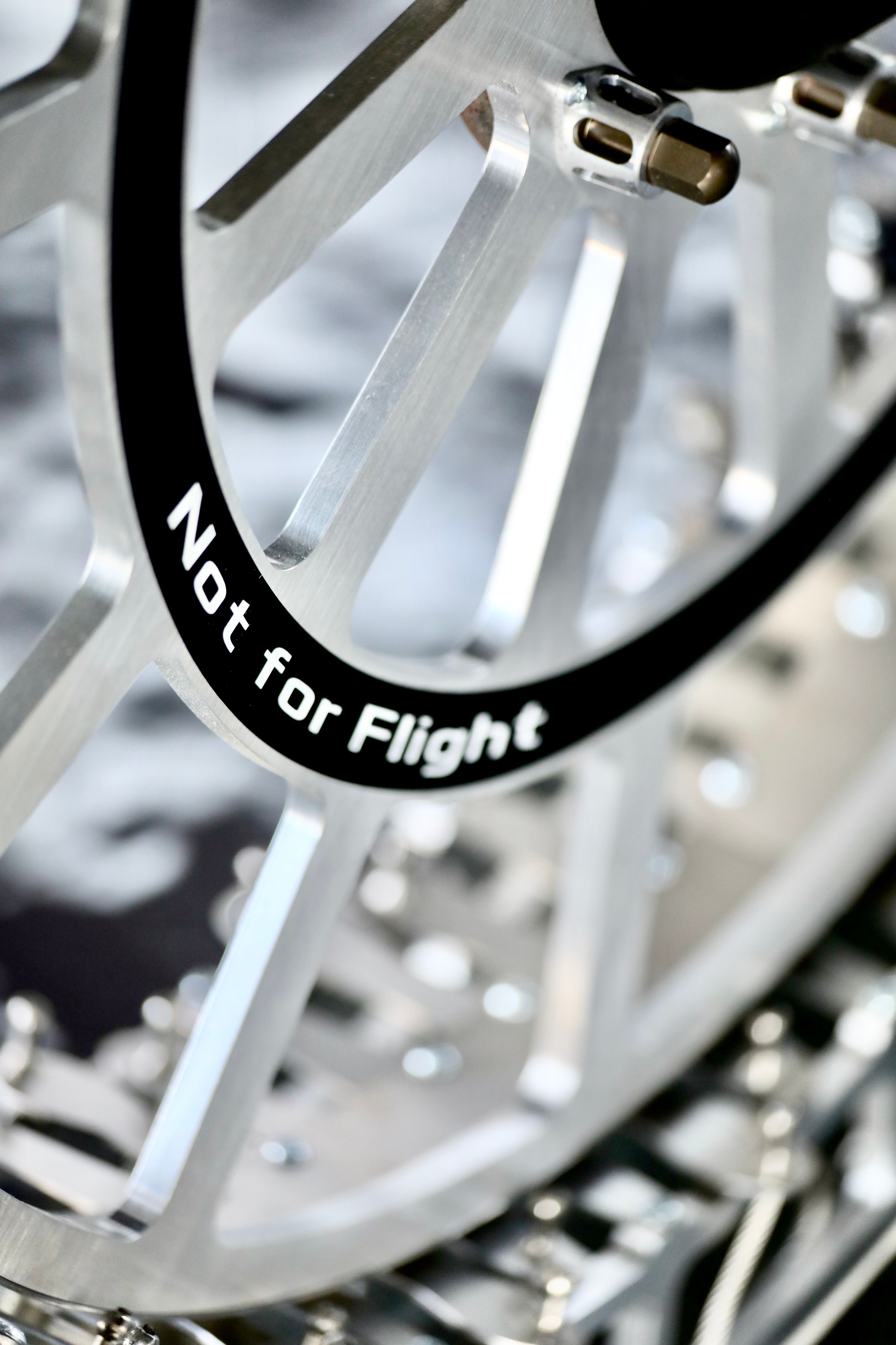 Close-up of Metallic Wheel with 'Not for Flight' Marking · Free Stock Photo