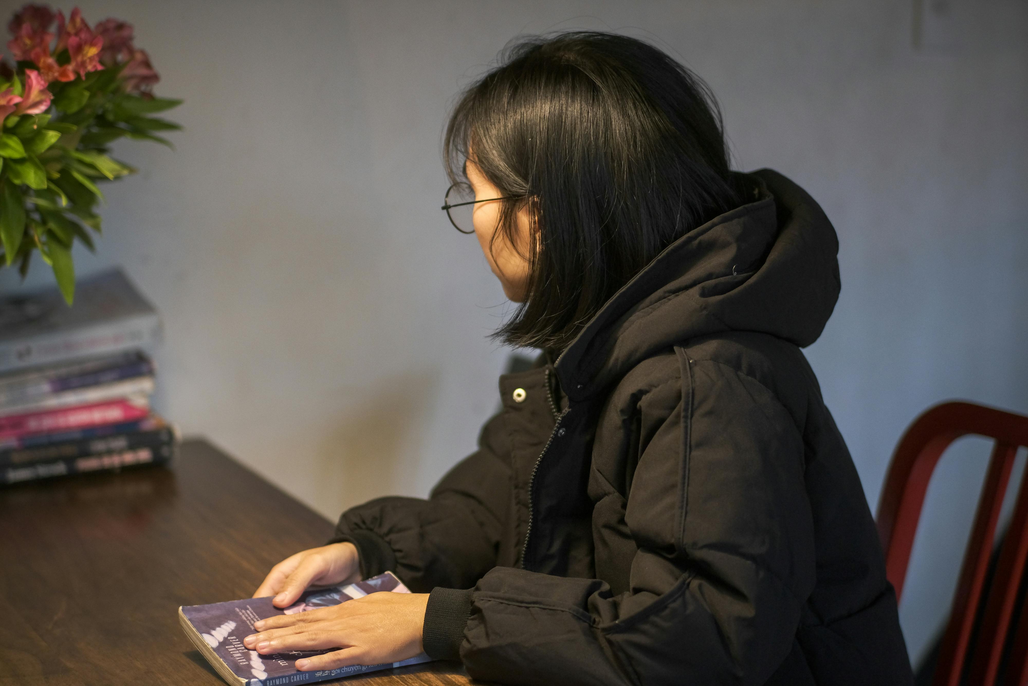 Free A woman reading in a cozy setting, captured in Hue, Vietnam. Stock Photo