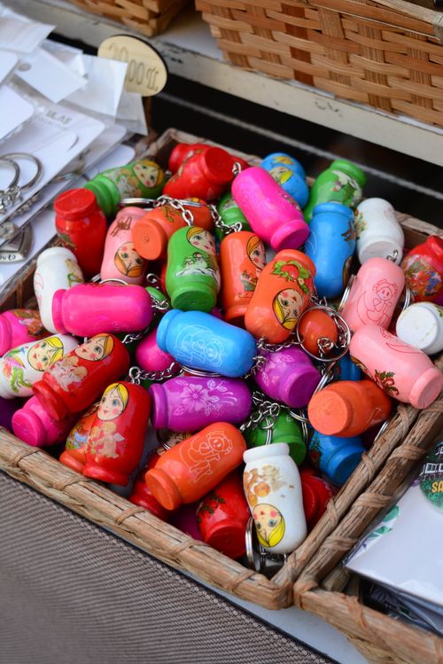 Free Vibrant collection of Matryoshka doll keychains displayed in a market basket. Stock Photo