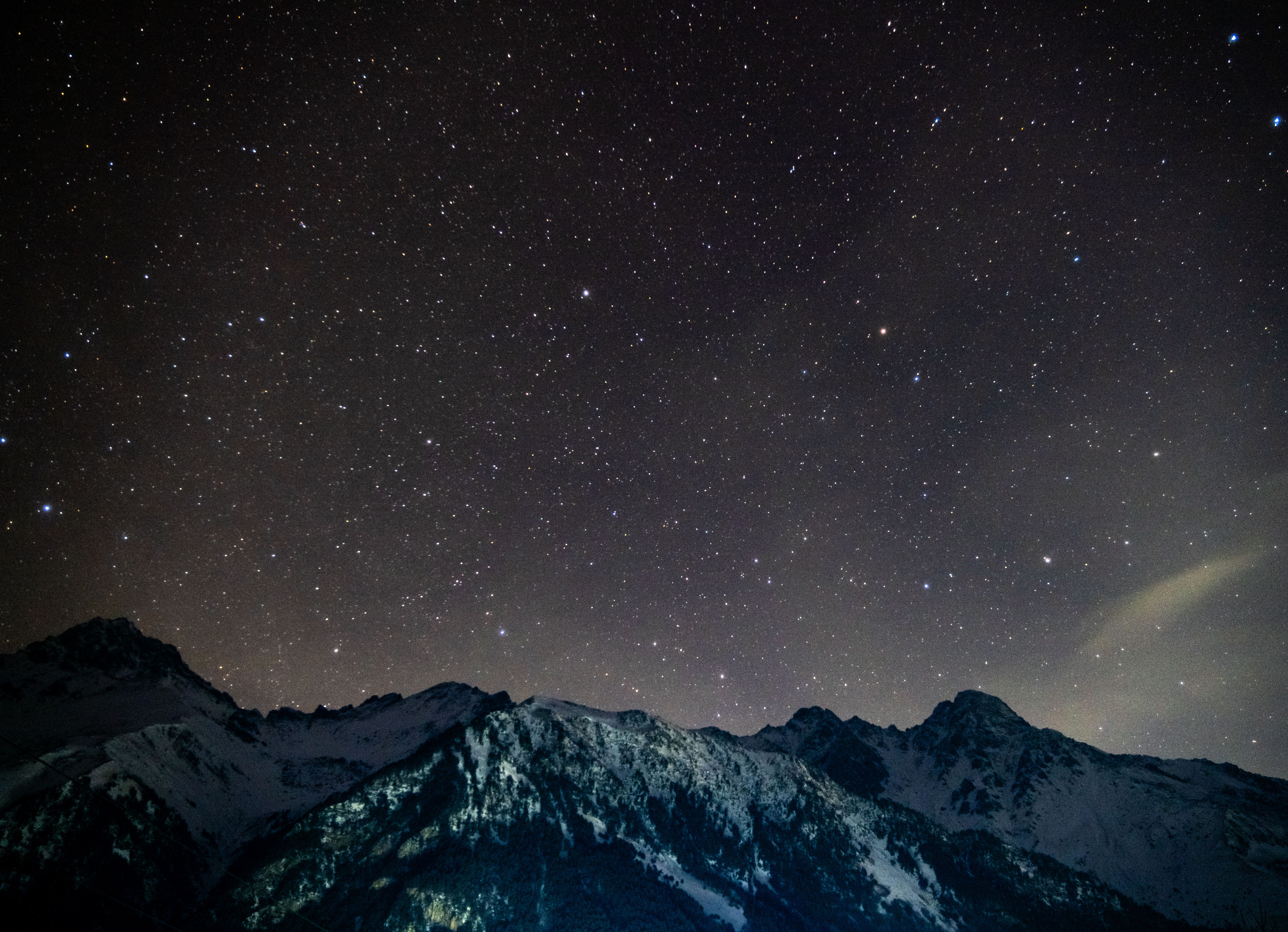 Starry Night Sky Over Snow-Capped Mountains · Free Stock Photo