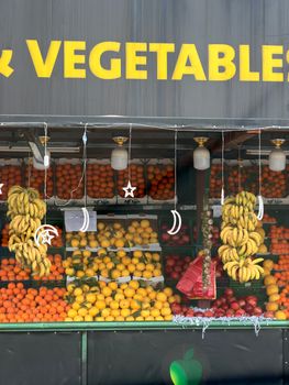 Vibrant market stall with fresh fruits and veggies in Amman, Jordan.