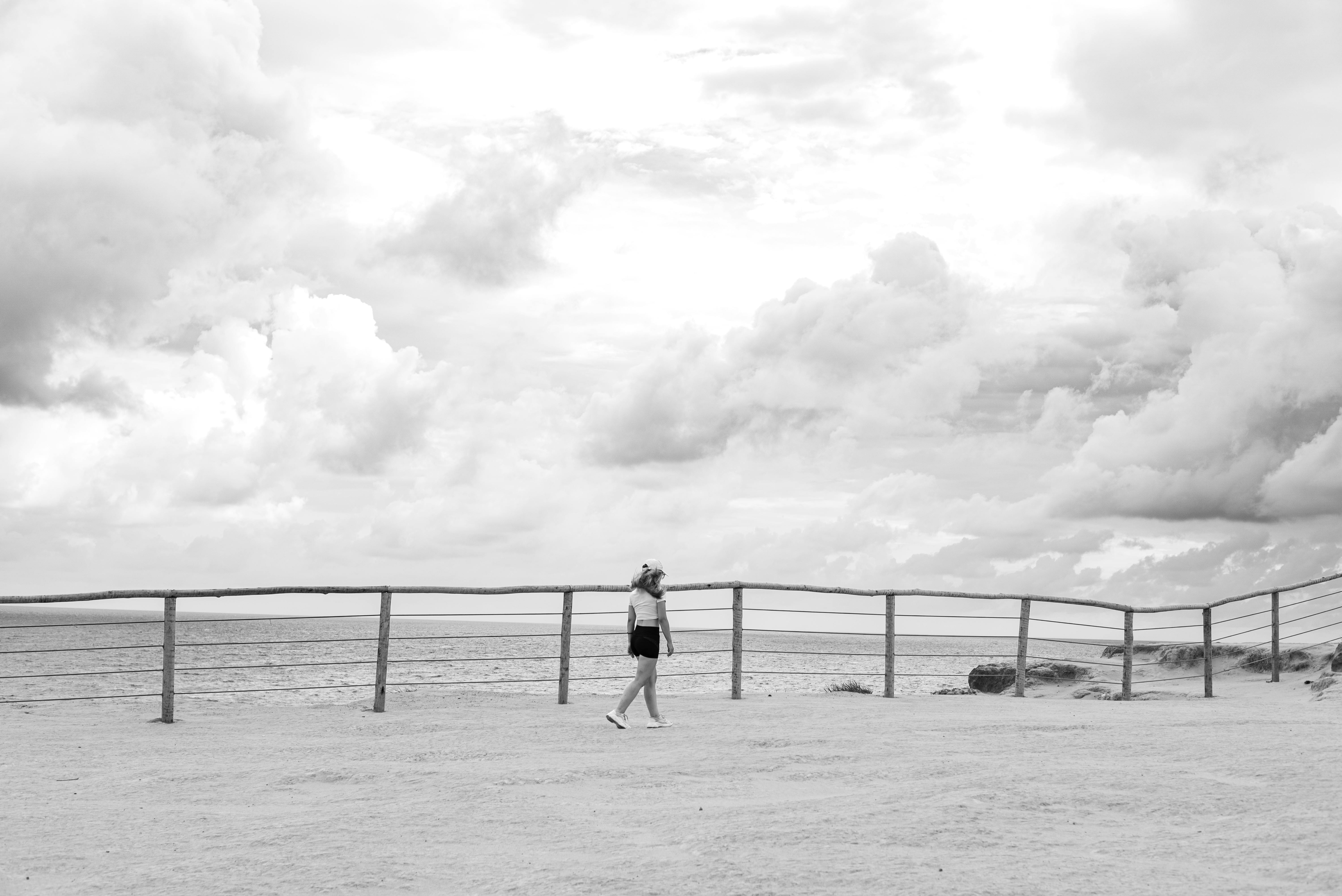 Gratis En person rusler langs en kyststi under en dramatisk overskyet himmel i Natal, Brasil. Arkivbilde