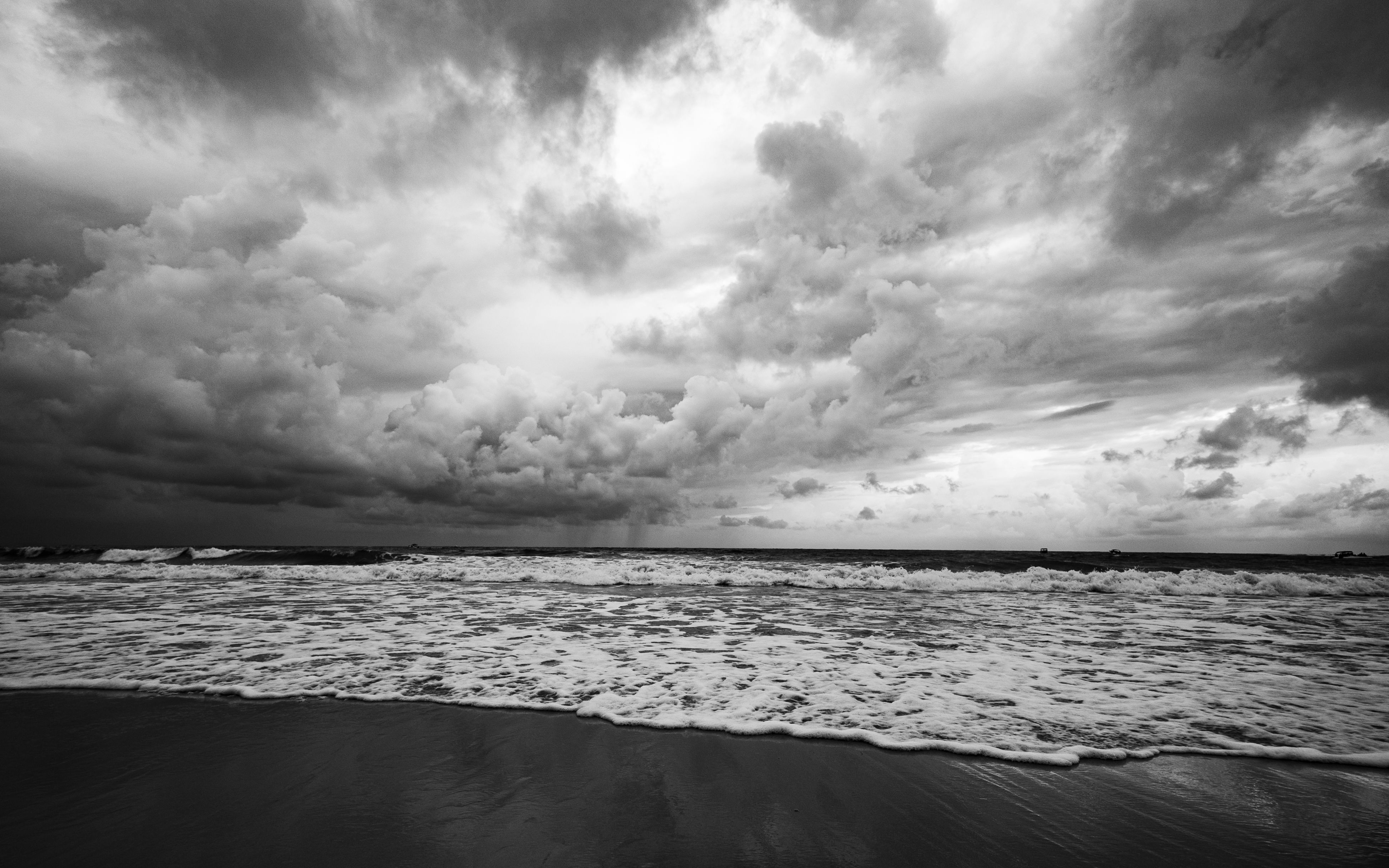 Stormy clouds and waves create a dramatic scene on a Brazilian beach in Natal.